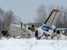 Russian Emergency ministry rescue workers search the site of a deadly ATR-72 plane crash outside Tyumen in Siberia, Russia on Monday, April 2, 2012. A passenger plane crashed shortly after takeoff. (AP Photo/Marat Gubaydullin)