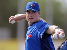 Toronto Blue Jays manager John Farrell throws batting practice to his players before their spring training baseball game against the Pittsburgh Pirates in Dunedin, Fla. on Sunday, April 1, 2012. (AP Photo/Kathy Willens)