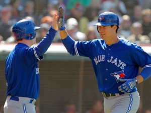 Toronto Blue Jays' Kelly Johnson, right, is congratulated by teammate Adam Lind after he hit a solo home run in the ninth inning against the Cleveland Indians in a baseball game in Cleveland on Saturday, April 7, 2012. (AP Photo/Amy Sancetta)