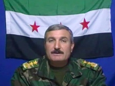 In this Nov. 21, 2011 file image made from video, Syrian Commander Riad al-Asaad, who heads a group of Syrian army defectors appears on a video posted on the group's Facebook page, as he retracts earlier claims that his followers launched an attack on Baath Part Headquarters inside the Syrian capital, Damascus. A U.N.-brokered peace deal for Syria appeared to collapse Sunday as the government made a new demand that its opponents provide "written guarantees" to lay down their weapons before regime forces withdraw from cities, a call swiftly rejected by the country's main rebel group. The commander of the rebel Free Syrian Army, Riad al-Asaad, said his group was prepared to abide by the Annan agreement, but rejected the government's new unilateral demand. (AP Photo/Facebook, File) 