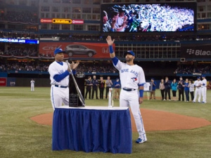 Toronto Blue Jays Jose Bautista (right) is presented with the Silver Slugger Award by hitting coach Dwayne Murphy ahead of their home opener against the Boston Red Sox in MLB baseball action in Toronto on Monday, April 9, 2012. (THE CANADIAN PRESS/Chris Young)