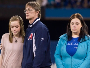 Tanner Craswell's girlfriend Shanya Conway (left) is consoled by his father Keith Craswell (centre) as the Toronto Blue Jays honour ahead of their home opener against the Boston Red Sox in Toronto on Monday April 9, 2012 Tanner Craswell and Mitch Maclean, two P.E.I. baseball players who were murdered last year. The family's of Mitch MacLean (left) father Irwin MacLean, mother Dianne Maclean and brother Morgan MacLean and the family of Tanner Craswell, father Keith Craswell, sister Melissa Hall, sister Chantell Gillis, Shanya Conway (Tanner Craswell's girlfriend) brother Adam MacDonald and Katrina Abou Risk (his brother' girlfriend) were invited to the pitching mound, greeted by players and presented with signed shirts. (THE CANADIAN PRESS/Chris Young)