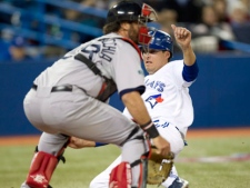 Toronto Blue Jays Kelly Johnson (right) slides in to score behind Boston Red Sox catcher Jarrod Saltalamacchia during third inning AL action in Toronto on Tuesday, April 10, 2012. (THE CANADIAN PRESS/Frank Gunn)