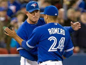 Toronto Blue Jays manager John Farrell congratulates starting pitcher Ricky Romero after defeating the Boston Red Sox, 3-1, in a baseball game in Toronto on Wednesday, April 11, 2012. (AP Photo/The Canadian Press, Frank Gunn)