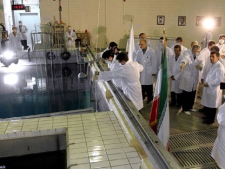 In this Feb. 15, 2012, file photo, provided by the Iranian President's Office, Iranian President Mahmoud Ahmadinejad, right, is escorted by technicians during a tour of Tehran's research reactor center in northern Tehran, Iran. Iran's envoys are heading for nuclear talks with confidence that the chips are falling their way. (AP Photo/Iranian President's Office, File)