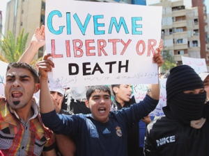 Anti-Syrian regime protesters chant slogans against Syrian President Bashar Assad during a demonstration after Friday prayers in Beirut, Lebanon on Friday, April 13, 2012. (AP Photo/Bilal Hussein)