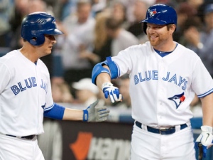 Toronto Blue Jays' Kelly Johnson (left) is congratulated by teammate Adam Lind after hitting a home run against Baltimore Orioles during the first inning of MLB baseball action in Toronto on Friday, April 13 , 2012. (THE CANADIAN PRESS/Chris Young)