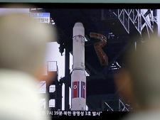 South Korean Buddhist monks watch a TV news report at a train station in Seoul, South Korea, on Friday, April 13, 2012, about the failed launch of North Korea's long-range rocket. (AP Photo/Lee Jin-man)