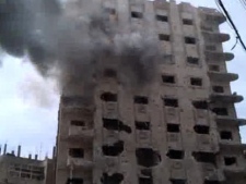 This image made from amateur video and released by Bambuser Saturday, April 14, 2012 purports to show smoke from shelling in Homs, Syria. (AP Photo/Bambuser via AP video)