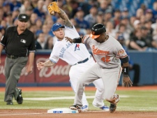 Baltimore Orioles Wilson Betemit (right) steals third base in front of Toronto Blue Jays Brett Lawrie during the second inning of MLB baseball action in Toronto on Sunday, April 15 , 2012. THE CANADIAN PRESS/Chris Young