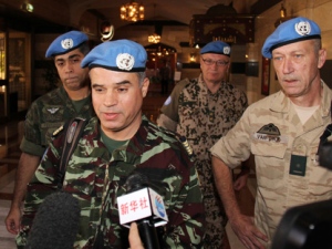 Moroccan Col. Ahmed Himmiche, foreground, is flanked by other U.N. observers as he talks to journalists before leaving the Sheraton Hotel in Damascus, Syria, Monday, April 16, 2012. (AP Photo/Bassem Tellawi)