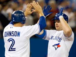 Toronto Blue Jays Adam Lind, right, is congratulated by teammate Kelly Johnson after they scored on his two run homer off Tampa Bay Rays starting pitcher Jeff Niemann in the third inning of a baseball game in Toronto on Tuesday, April 17, 2012. (AP Photo/The Canadian Press, Frank Gunn)