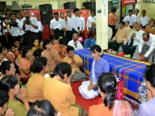 Myanmar democracy leader Aung San Suu Kyi, center, receives gestures of respect from members of her National League for Democracy party during a ceremony honoring the ederly at the party's headquarters on Wednesday, April 18, 2012, in Yangon, Myanmar. (AP Photo/Khin Maung Win)