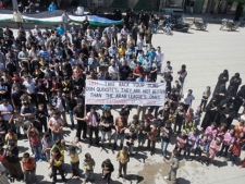 In this citizen journalism image provided by the Local Coordination Committees in Syria and accessed on Tuesday, April 17, 2012, Syrians chant slogans during a demonstration in Kafranbel near Idlib, north Syria. (AP Photo/Local Coordination Committees in Syria) 