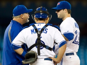 Toronto Blue Jays starting pitcher Brandon Morrow (right) talks with catcher Jeff Mathis and pitching coach Bruce Walton (left) on the mound during fourth inning AL action against the Tampa Bay Rays in Toronto on Wednesday, April 18, 2012. (THE CANADIAN PRESS/Frank Gunn)