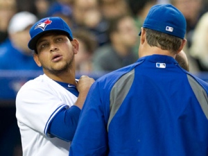 Toronto Blue Jays starting pitcher Henderson Alvarez checks his neck with manager John Farrell (right) after getting hit by an errant throw during second inning AL action against the Tampa Bay Rays in Toronto on Thursday, April 19, 2012. (THE CANADIAN PRESS/Frank Gunn)