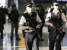 Armed police officers patrol the departure lounge of Terminal 5 at Heathrow Airport in London on Thursday, March 27, 2008. (AP Photo/Akira Suemori)