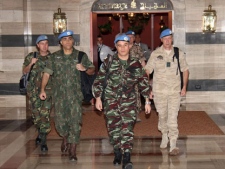 U.N. observers, led by Moroccan Col. Ahmed Himmiche, center, leave the Sheraton Hotel in Damascus, Syria, Monday, April 16, 2012. (AP Photo/Bassem Tellawi)