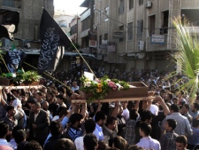 In this Saturday, April 21, 2012 photo, Syrian mourners carry the bodies of an infant, Adam al Najjar, and Free Syrian Army fighter, Mowaffaq al Nablsi, 42, during their funeral in Douma, a suburb of Damascus, Syria. Syrian troops stormed and shelled districts in a suburb of the capital Damascus Sunday, activists said, a day after the Security Council voted to expand the number of U.N. truce monitors from 30 to 300 in hopes of salvaging an international peace plan marred by continued fighting between the military and rebels. (AP Photo)