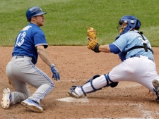 Toronto Blue Jays' Brett Lawrie beats the tag by Kansas City Royals catcher Humberto Quintero to steal home during the eighth inning of a baseball game on Sunday, April 22, 2012, in Kansas City, Mo. (AP Photo/Charlie Riedel)