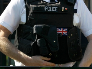 A police officer keeps watch Wednesday, March 28, 2012. (AP Photo/Kirsty Wigglesworth)