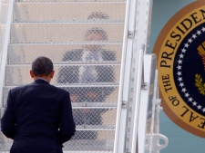 In this April 25, 2012 file photo, President Barack Obama's reflection can be seen on the steps as he boards Air Force One at Buckley Air Force Base in Aurora, Colo. (AP Photo/Ed Andrieski)