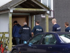 Danish police enter an appartment complex in Herlev, in the outskirts of Copenhagen, for a search Friday, April 27, 2012, after three men were arrested on suspicion of plotting a terror act. (AP Photo/Polfoto, Jens Dresling)