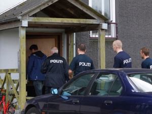 Danish police enter an appartment complex in Herlev, in the outskirts of Copenhagen, for a search Friday, April 27, 2012, after three men were arrested on suspicion of plotting a terror act. (AP Photo/Polfoto, Jens Dresling)