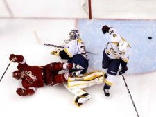 After tripping over Nashville Predators goalie Pekka Rinne and forward Mike Fisher, Phoenix Coyotes captain Shane Doan celebrates a goal by teammate Antoine Vermette in the first period during Game 2 of an NHL Western Conference semifinal playoff series Sunday, April 29, 2012, in Glendale, Ariz. The Coyotes defeated the Predators 5-3. (AP Photo/Ross D. Franklin)