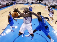 Oklahoma City Thunder centre Kendrick Perkins (5) is fouled by Dallas Mavericks centre Ian Mahinmi, right, in the fourth quarter of Game 2 in the first round of the NBA playoffs in Oklahoma City, Tuesday, May 1, 2012. Oklahoma City won 102-99. (AP Photo/Sue Ogrocki)