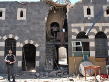 In this Friday, April 20, 2012 file photo, a Syrian rebel stands inside a damaged historic house that was shelled by the Syrian security forces, at al-Hamidiya neighborhood, in the old city of Homs province, central Syria. (AP Photo)