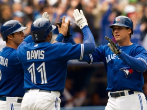 Toronto Blue Jays Kelly Johnson (right), J.P. Arencibia (left) and Rajai Davis celebrate after scoring on teammate Yune Escobar's bases loaded triple during fourth inning AL action against the Texas Rangers in Toronto on Wednesday May 2, 2012. THE CANADIAN PRESS/Frank Gunn