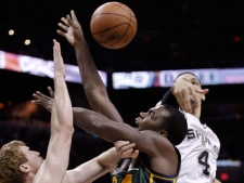 Utah Jazz's Paul Millsap (24) works between San Antonio Spurs' Matt Bonner, left, and Danny Green during the second quarter of Game 2 of a first-round NBA basketball playoff series on Wednesday, May 2, 2012, in San Antonio. (AP Photo/Eric Gay)