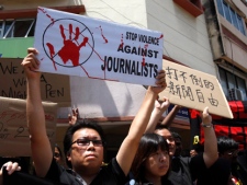 Members of the press hold placards during a rally to mark World Press Freedom Day in Kuala Lumpur, Malaysia, Thursday, May 3, 2012. (AP Photo/Lai Seng Sin)