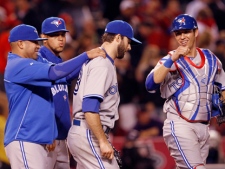 Toronto Blue Jays pitcher Brandon Morrow, centre, catcher J.P. Arencibia, right, and others celebrate Morrow's three-hit, complete-game shutout of the Los Angeles Angels of Anaheim in an American League baseball game in Anaheim, Calif., Thursday, May 3, 2012. The Jays won 5-0. (AP Photo/Reed Saxon)