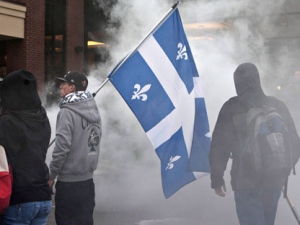 Demonstrators gather in front of a hotel as the Quebec Liberal Party is meeting on Friday, May 4, 2012 in Victoriaville, Quebec. A violent standoff erupted on the streets of a small city where Quebec's governing party was holding its weekend convention, as protesters and provincial police rained physical abuse on each other Friday. (THE CANADIAN PRESS/Jacques Boissinot)