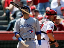 Toronto Blue Jays' Jose Bautista, left, tosses his bat after striking out with a runner on base to end the top of the seventh inning as Los Angeles Angels catcher Chris Iannetta turns away during a baseball game in Anaheim, Calif., Sunday, May 6, 2012. (AP Photo/Chris Carlson)