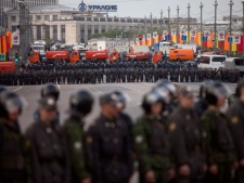 Russian Police officers stand facing an opposition protest to block the road in the center of Moscow during a rally, Sunday, May 6, 2012. Thousands of protesters are gathering at a Moscow square for a march on the eve of Vladimir Putin's inauguration as president.The protest has been boldly billed by opposition leaders as the "March of a Million," but the early turnout indicates the numbers won't be anywhere close to that. About 5,000 had gathered an hour before the planned start of the Sunday march.(AP Photo/Alexander Zemlianichenko)