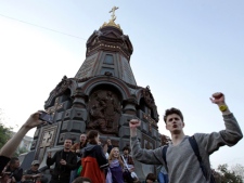 Opposition supporters gesture during a sit-in protest across the street from the presidential administrations building in downtown Moscow early Tuesday, May 8, 2012, a day after President Vladimir Putin's inauguration. (AP Photo/Sergey Ponomarev)