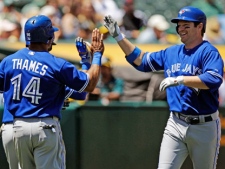 Toronto Blue Jays' Adam Lind, right, celebrates his two-run home run with Eric Thames (14) during the fourth inning of a baseball game against the Oakland Athletics on Wednesday, May 9, 2012, in Oakland, Calif. (AP Photo/Marcio Jose Sanchez)