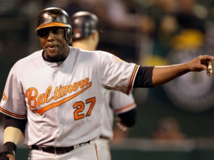 Baltimore Orioles' Vladimir Guerrero celebrates after scoring against the Oakland Athletics during the seventh inning of a baseball game Monday, Aug. 15, 2011, in Oakland, Calif. (AP Photo/Ben Margot)