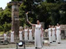 A high priestess, holds a torch with the Olympic flame during the lighting of the flame ceremony on Thursday, May 10, 2012, in Ancient Olympia, Greece. The flame will be carried from the birthplace of the Ancient Olympics to London, where the 2012 Summer Games will take place from July 27-Aug. 12. (AP Photo/Petros Giannakouri