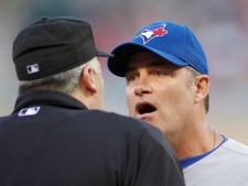 Toronto Blue Jays manager John Farrell argues with umpire Bill Welke in the third inning against the Minnesota Twins during a baseball game in Minneapolis on Thursday, May 10, 2012. (AP Photo/Andy King)