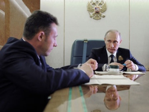 Russian President Vladimir Putin, right, listens to Igor Khokhlamckikh, the head of a tank-assembling division of Uralvagonzavod on board a plane en route from Yekaterinburg to Nizhny Tagil on Thursday, May 10, 2012.(AP Photo/RIA Novosti, Alexei Druzhinin, Government Press Service)