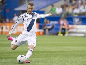 LA Galaxy's David Beckham scores a goal against the Montreal Impact during second half MLS soccer action Saturday, May 12, 2012 in Montreal. THE CANADIAN PRESS/Paul Chiasson