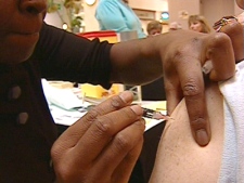 An individual gets a flu shot at an inoculation clinic offered by the province of Ontario.