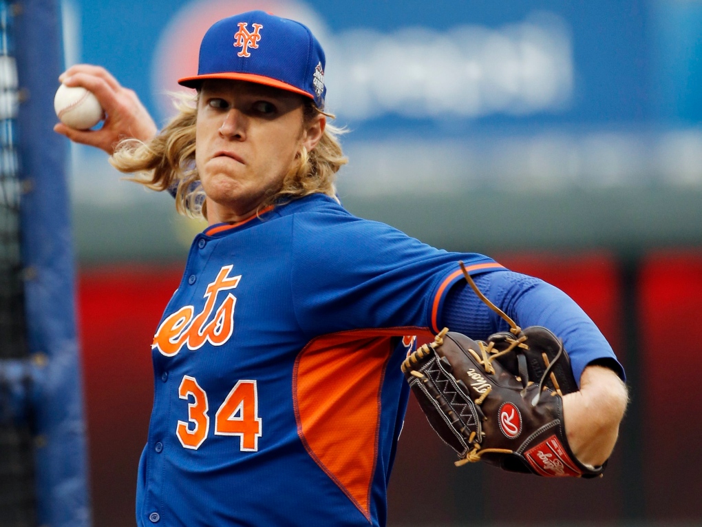 Mets starting pitcher Noah Syndergaard(Thor) throws the first pitch - Gold  Medal Impressions