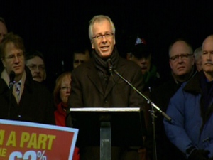 Liberal Leader Stephane Dion addresses supporters at a rally in Toronto, as NDP Leader Jack Layton stands to Dion's left on Saturday, Dec. 6, 2008.