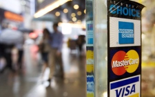 In this July 27, 2007, file photo, signs for American Express, Master Card and Visa credit cards are shown on a New York store's door. (AP / Mark Lennihan)