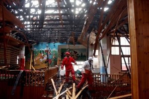 Palestinian medics examine the damage inside the burned building of the Quds hospital after is was hit during Israeli military operations in Gaza City, Friday, Jan. 16, 2009. (AP / Khalil Hamra)